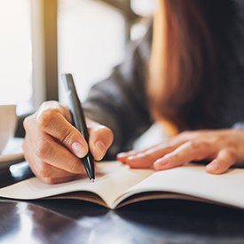 Woman making notes in her sleep journal