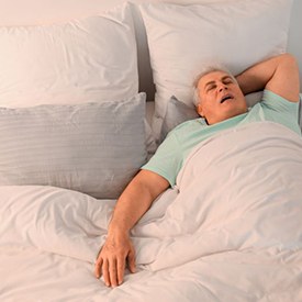 Snoring senior man in his bed