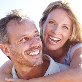 Smiling older man and woman outdoors