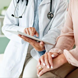 Doctor and patient looking at tablet together