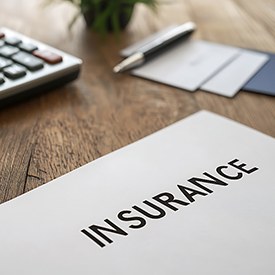 Insurance document next to calculator