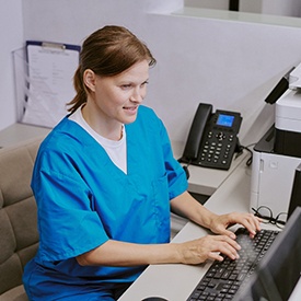 Sleep apnea therapy team member working at computer