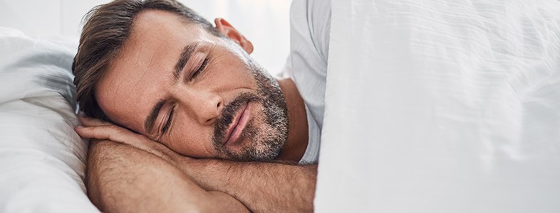 Man sleeping soundly in bed