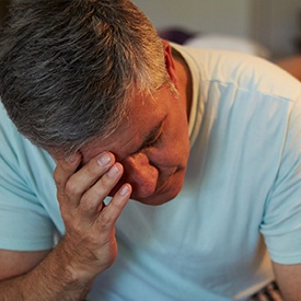 Frustrated man with head in hands