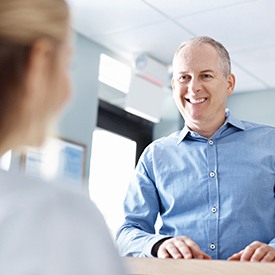 Smiling man at reception desk