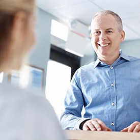 Smiling man at reception desk