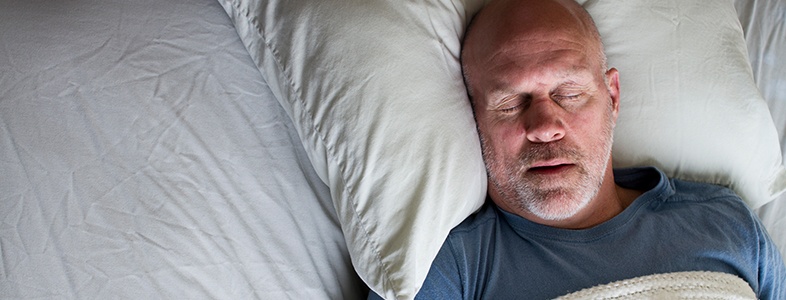 Man sleeping soundly in bed