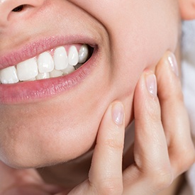 Closeup of woman holding jaw