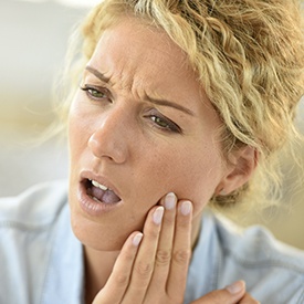 Woman holding jaw in pain