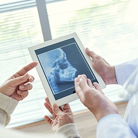 Dentists looking at skull x-ray