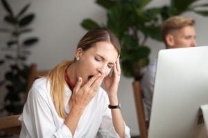 Woman with sleep apnea who looks tired at work