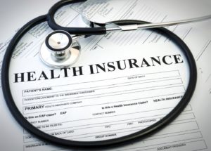 Health insurance form for sleep apnea treatment beneath stethoscope