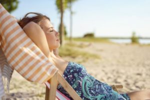 Woman taking a nap on the beach