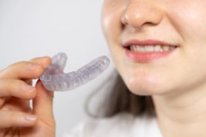 Close-up of woman holding splint for TMJ therapy