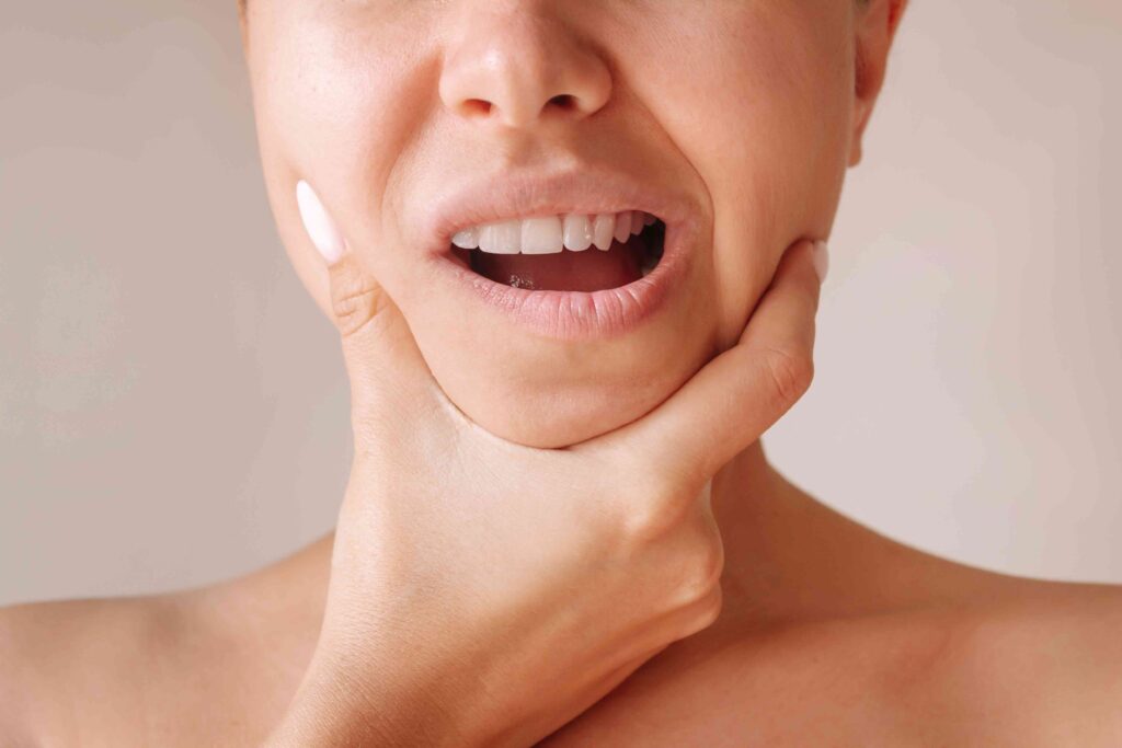 Woman holding her jaw