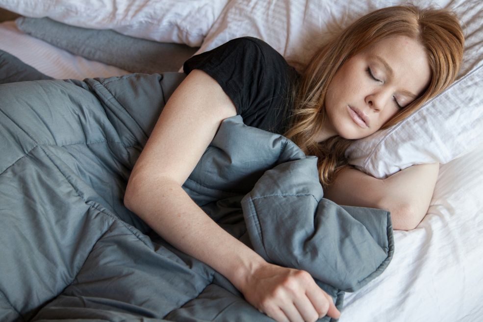 A woman using a weighted blanket.